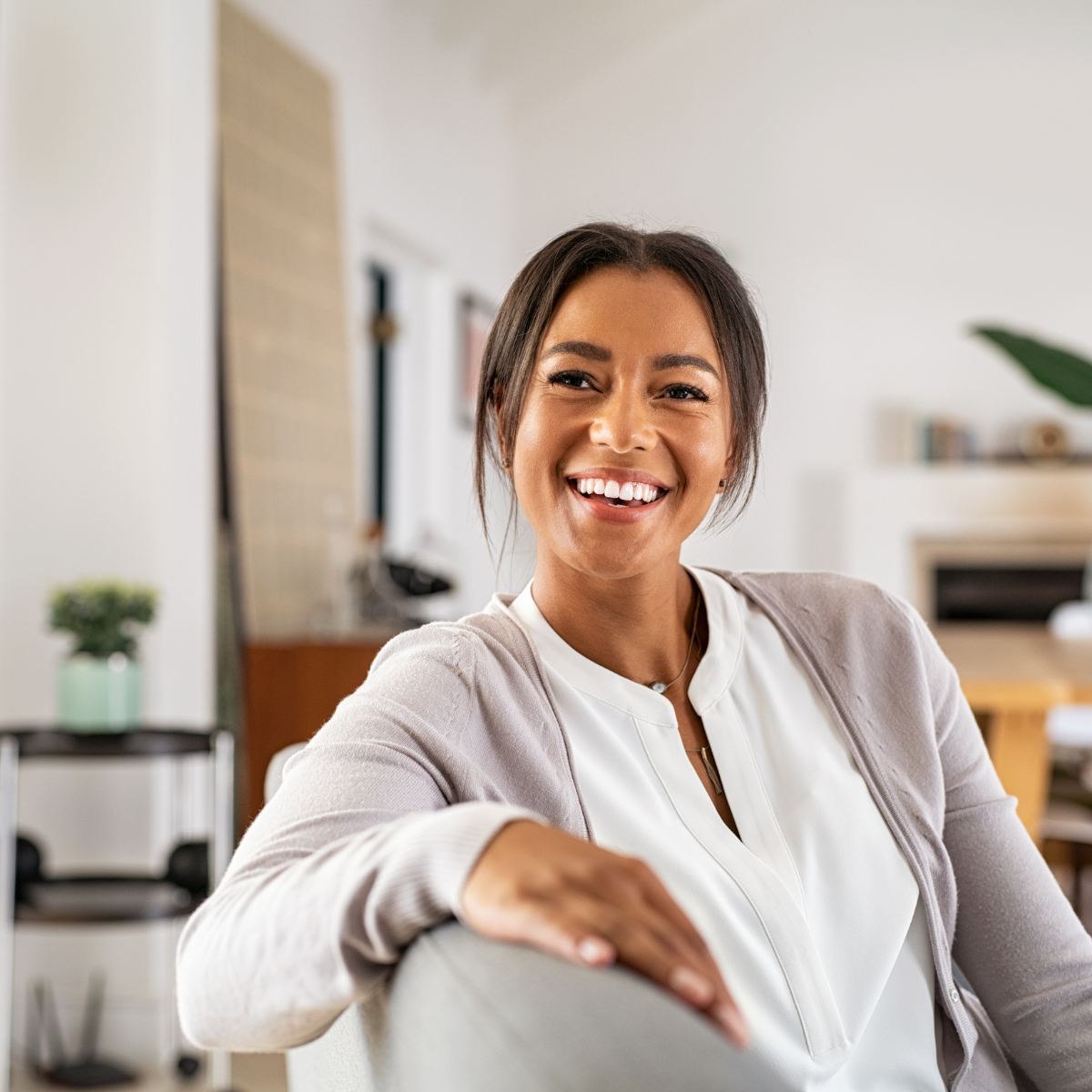 Woman smiling on kitchen chair