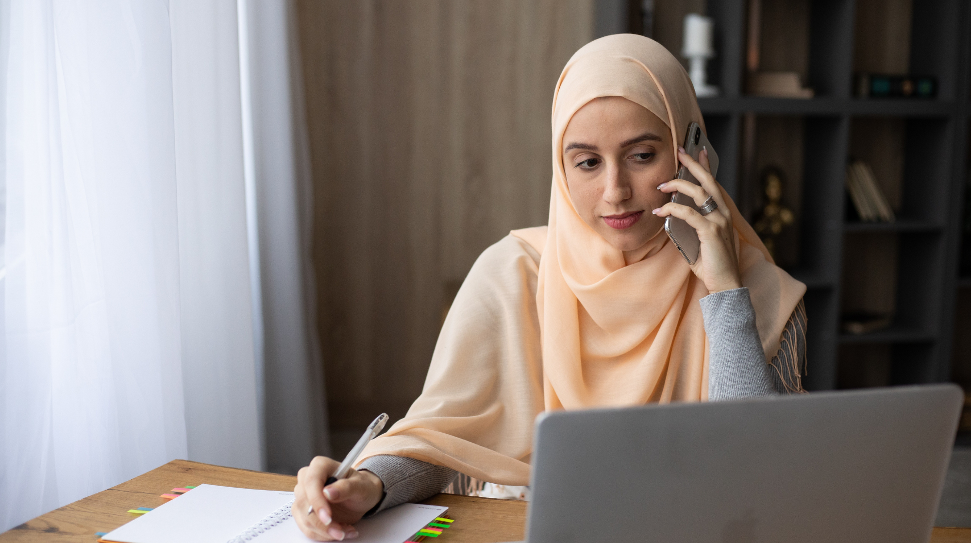 Woman wearing hijab on phone